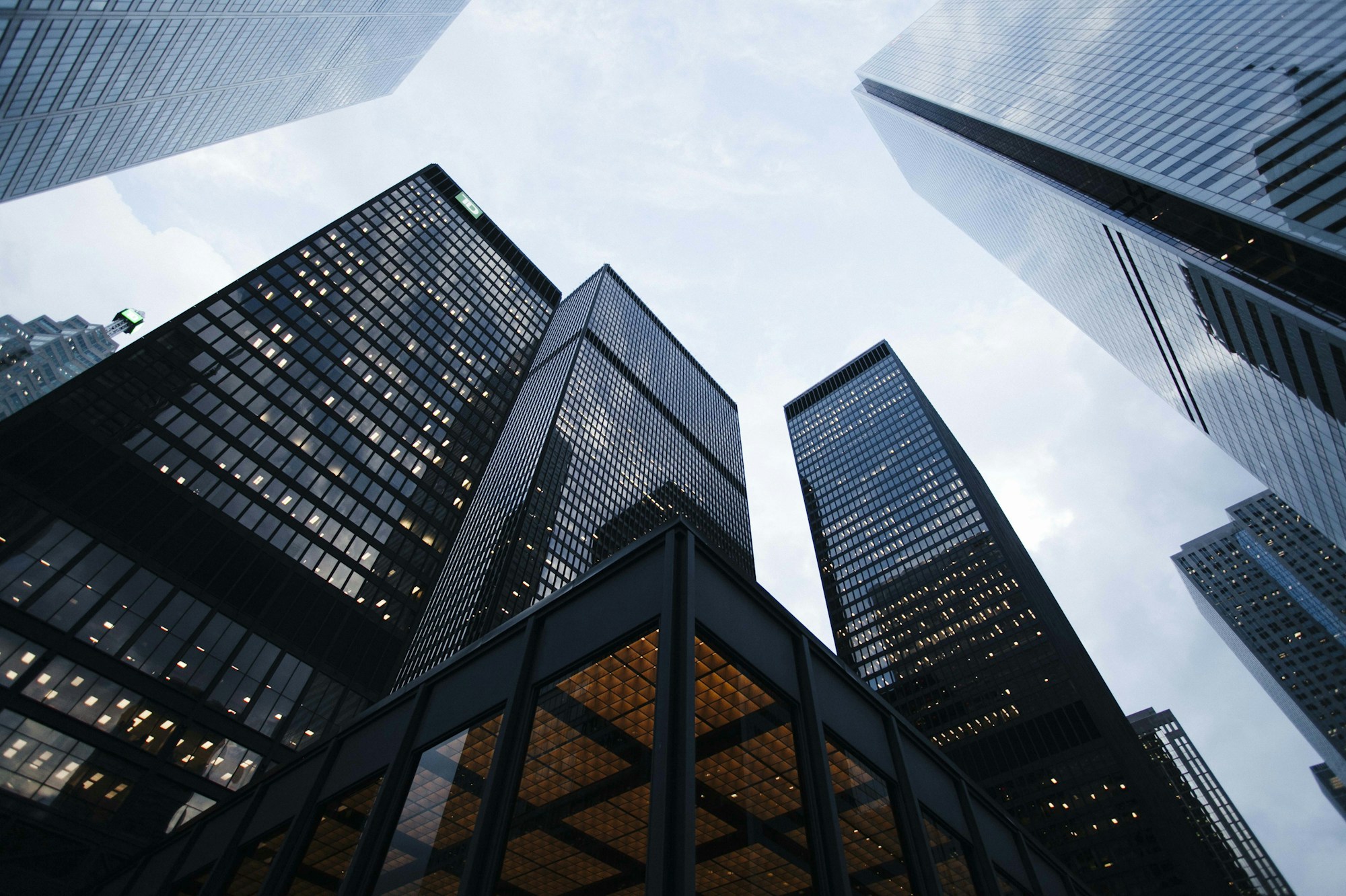 Glass towers rising toward an open blue sky